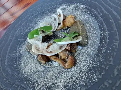 a plate of food with onions and greens on it at Matt's Place in Cape Town