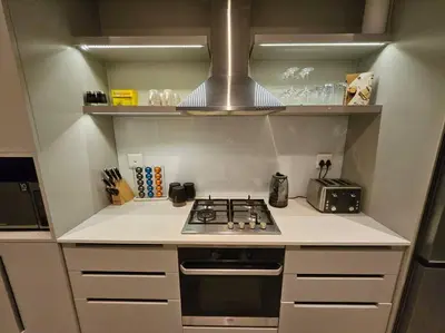 a kitchen with a stove top oven in a kitchen at Central - Whale Watching Paradise -Self check in in Hermanus
