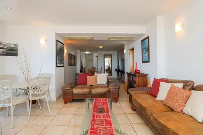 a living room with a couch and chairs and a table at 506 Hibernian Towers Luxury Self Catering Apartment Strand Cape Town South Africa in Cape Town