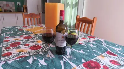 a bottle of wine and two glasses on a table at Sonvanger 3 in Paarl