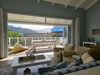 a living room with a couch and a table at Fijnbos in Pringle Bay