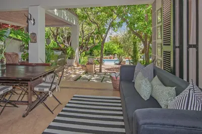 a living room with a couch and a table at Franschhoek villa in Franschhoek