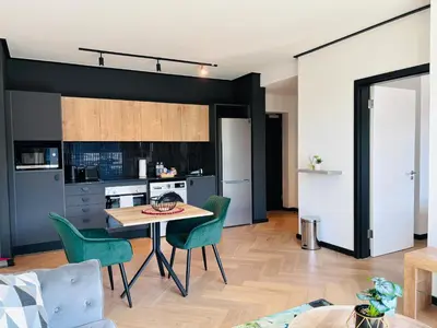 a kitchen and dining room with a table and chairs at Zals Luxury -Nine Palms in Cape Town