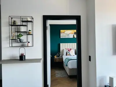 a bedroom with a bed and a mirror at Zals Luxury -Nine Palms in Cape Town