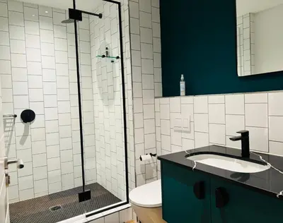 a bathroom with a sink and a glass shower at Zals Luxury -Nine Palms in Cape Town