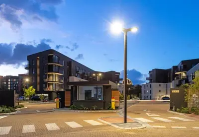 a street light in a parking lot next to a building at Zals Luxury -Nine Palms in Cape Town