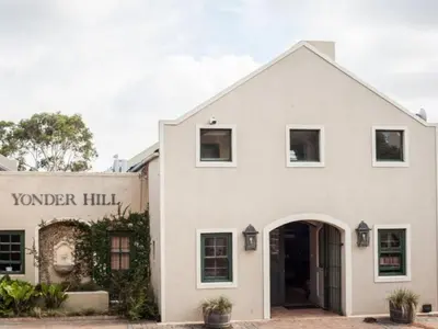 a white building with a sign for a vendor hall at Yonder Hill Accommodation in Raithby