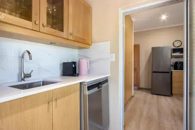 a kitchen with a sink and a refrigerator at Ocean View living in Hermanus