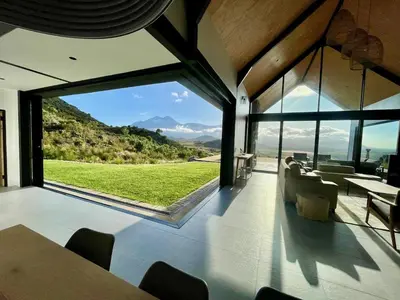 a dining room with a view of a mountain at The Unbound - Escape the Ordinary in Romansrivier