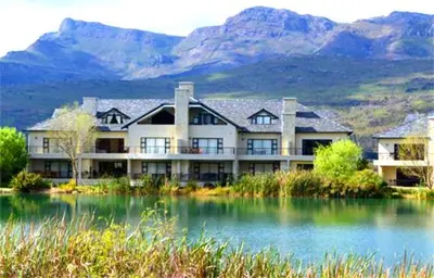 a large building with mountains in the background at Luxury Lodge 5F, Pearl Valley Golf Estate in Paarl