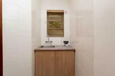 a bathroom with a sink and a window at Serena inn Room 1 in Cape Town