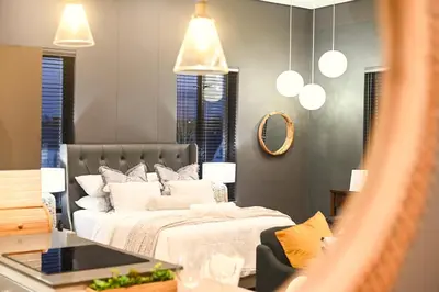 a bedroom with a bed and a mirror at 309 on Titanium in Cape Town