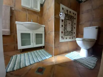 a bathroom with a toilet and a sink at The Haven Hide-Away in Fisherhaven