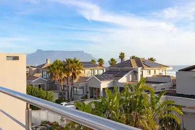 a view of houses with mountains in the background at Sunset Serenity Villa in Cape Town