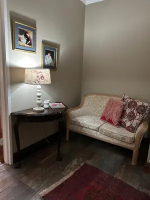 a living room with a couch and a table with a lamp at The Villa at Marnas Private Self-Catering Accommodation in Cape Town