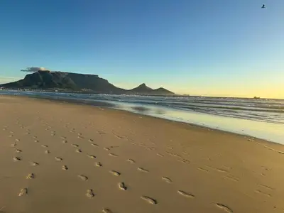 a footprints in the sand on a beach at Beautiful garden flat in Cape Town