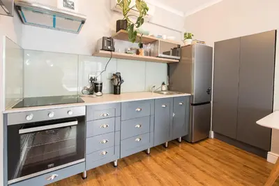 a kitchen with a sink and a stove at Beautiful garden flat in Cape Town