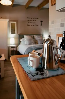 a kitchen counter with a coffee pot and a tea kettle at Dassenheuwel Farm Stay Cottages in Malmesbury