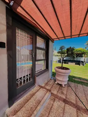 a patio with a window and a plant in a pot at Private garden guest house in Cape Town