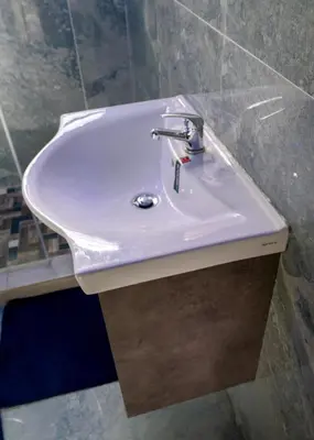 a white sink in a bathroom with marble walls at FB-Canatal Luxury Apartments in Cape Town