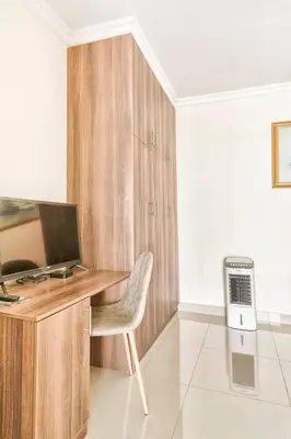 a desk with a computer and a chair in a room at Goodwood Oasis Free WiFi-Parking 2 in Cape Town
