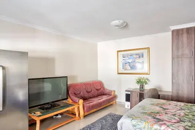 a living room with a couch and a flat screen tv at Goodwood Oasis FreeWiFi-Parking 1 in Cape Town