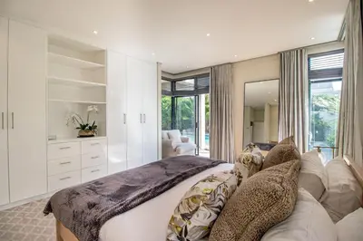 a bedroom with a large bed and a couch at Bayhill Terrace 17 by CTHA in Cape Town