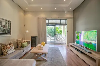 a living room with a large flat screen tv at Bayhill Terrace 17 by CTHA in Cape Town