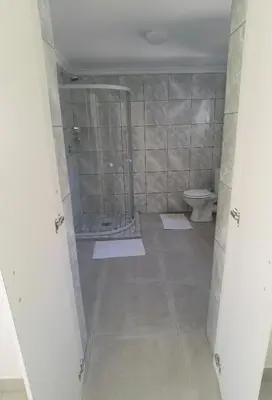 a bathroom with a shower and a toilet at The Somerset nest in Cape Town
