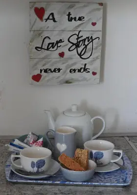 a tray with tea cups and a sign that says a two love six never ends at The Somerset nest in Cape Town