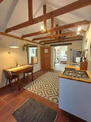 a kitchen with a table and a stove top oven at Garden City Summer in Cape Town