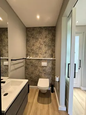 a bathroom with a tub and a toilet and a sink at Swanemeer Apartments in Cape Town