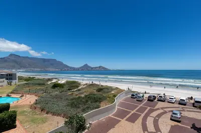 a view of a beach with cars parked in a parking lot at Neptune Isle 9 in Cape Town