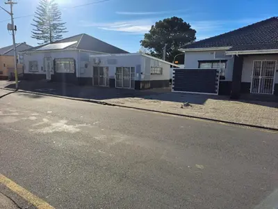 an empty street in front of a white house at Abyssinia Guest House in Cape Town