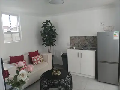 a living room with a couch and a table at Cethone Luxury Guest House in Cape Town