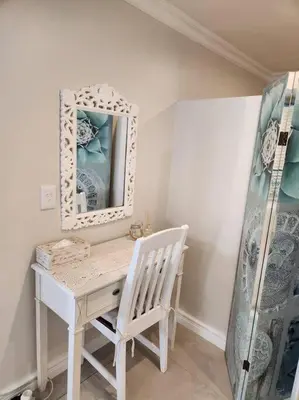 a white desk with a mirror and a chair at Haus Merwe Self Catering in Cape Town