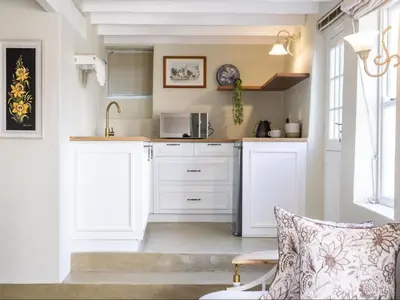 a kitchen with white cabinets and a microwave at Nantes-vue in Paarl