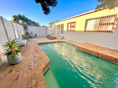 a swimming pool in the backyard of a house at 3 Bedroom Family Home with Pool in Cape Town