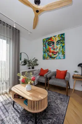 a living room with a painting of a woman at Nine Palms 223B in Cape Town