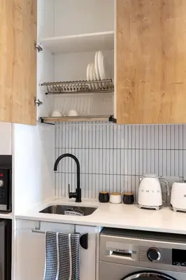 a kitchen with a sink and a stove top oven at Nine Palms 223B in Cape Town