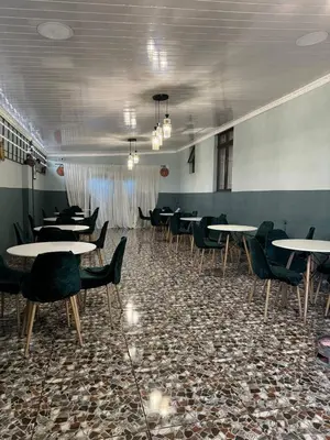 a dining room with tables and chairs in a room at Michu Guest house in Cape Town