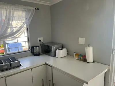 a kitchen counter with a toaster and a microwave at Claremont Studio in Cape Town
