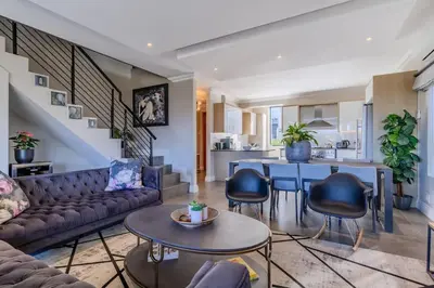 a living room with a couch and a table at Songbird D'Aria Cape Town luxury house on Wine Estate in Cape Town
