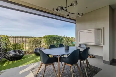 a dining room with a table and chairs at Songbird D'Aria Cape Town luxury house on Wine Estate in Cape Town