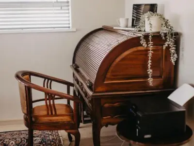a wooden piano and a chair in a room at Cape Select Luxury Accommodation in Durbanville