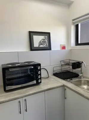 a microwave sitting on a counter in a kitchen at 31Ridge Road in Durbanville