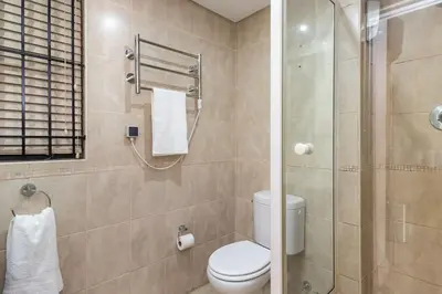 a bathroom with a toilet and a shower at Spacious 1 Bedroom Flat Church St Stellenbosch in Stellenbosch