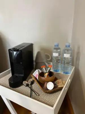 a desk with a computer and water bottles on it at Hephzibah inn Guest house and venue in Hermon