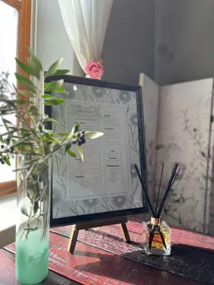 a framed certificate on a table with flowers in a vase at Hephzibah inn Guest house and venue in Hermon