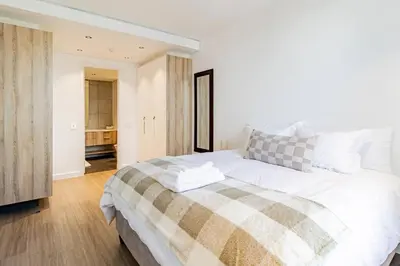 a bedroom with a large white bed in a room at 1 bed flat with Mountain view in Cape Town